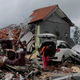 A man inspects the damage suffered by a building following a tsunami in Anyar, Indonesia, Sunday, Dec. 23, 2018.